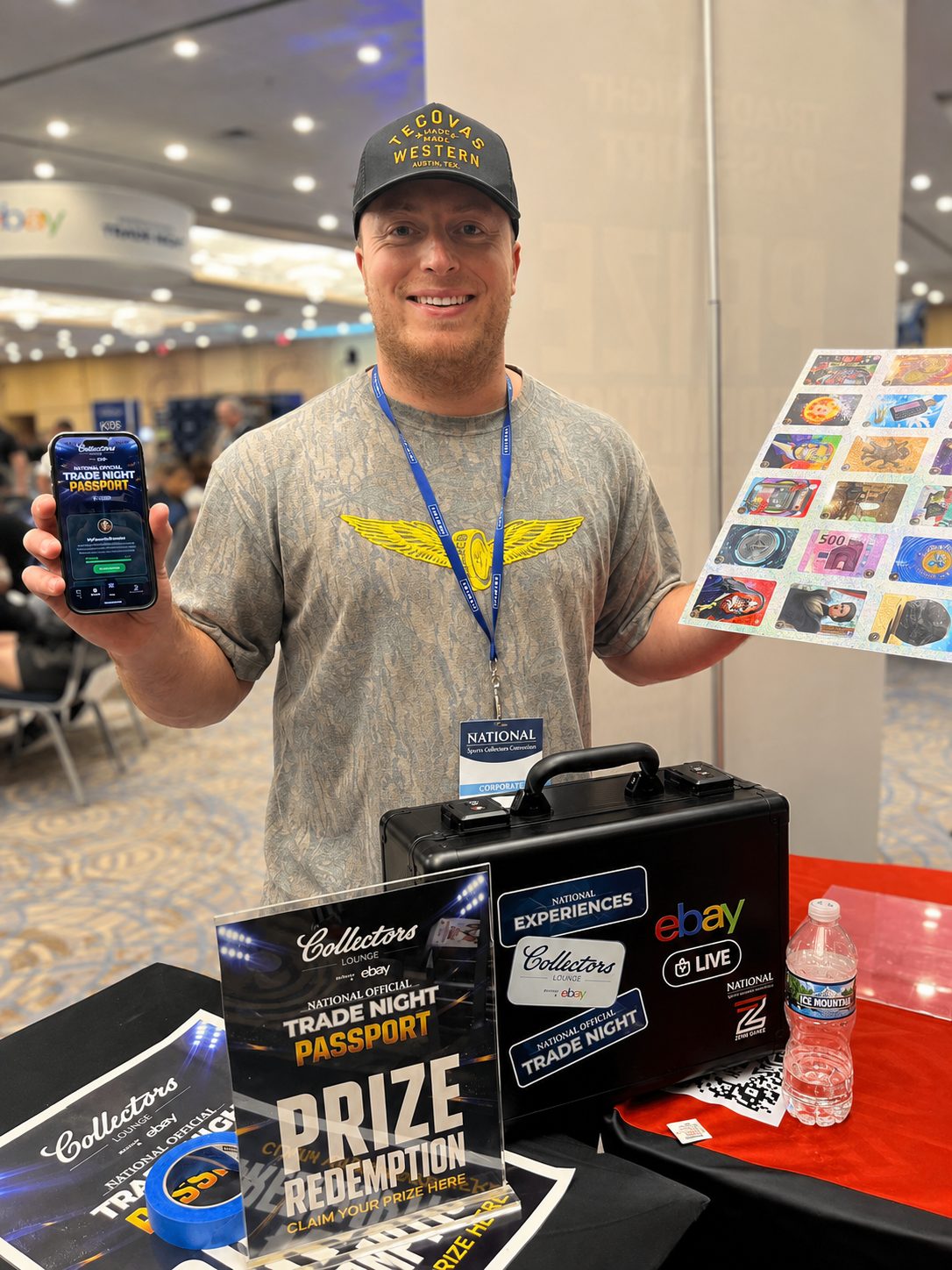 A staff member at the prize redemption booth showing the passport on a phone